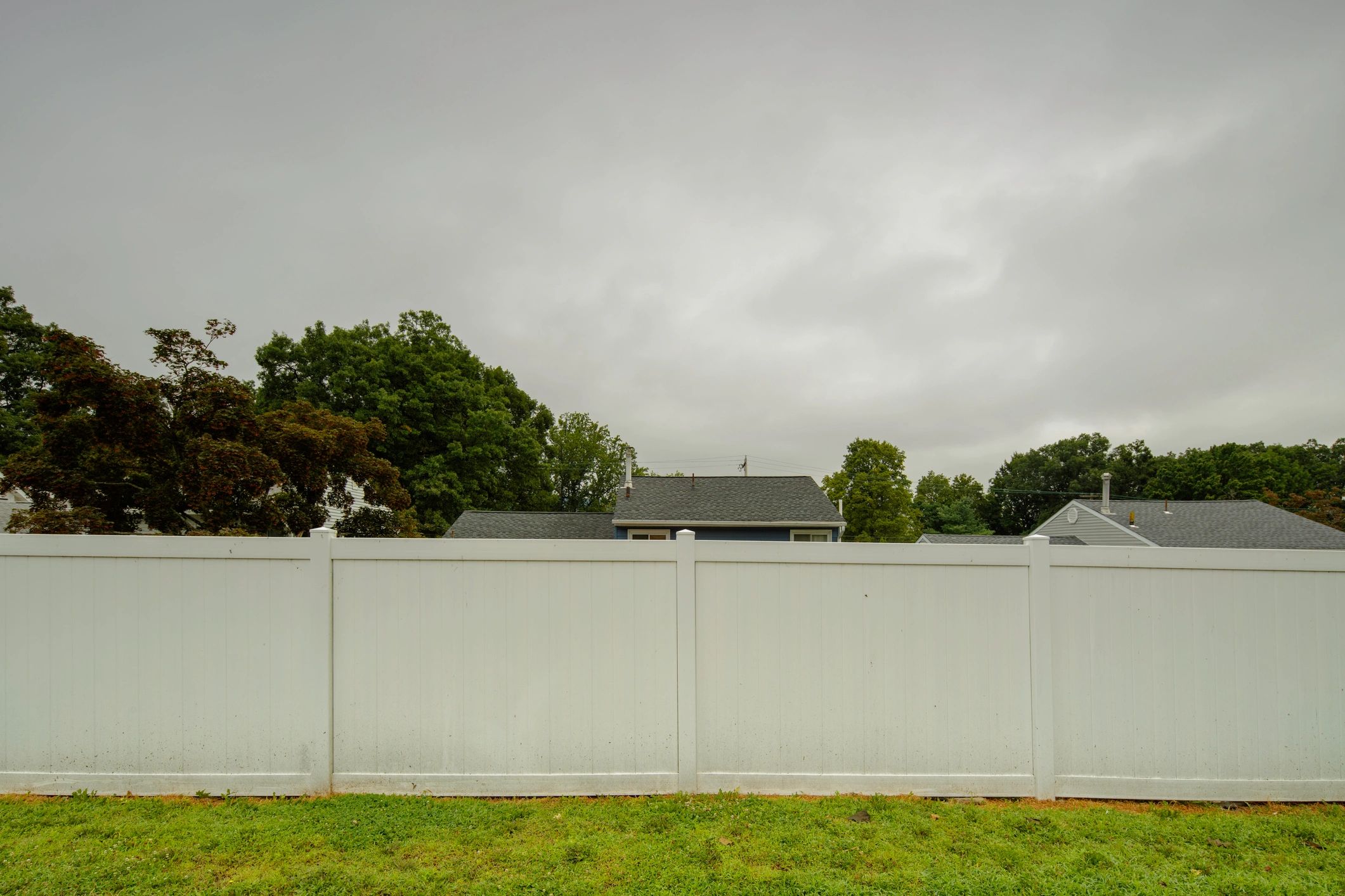 White vinyl fence near a home